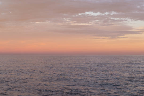 istock Orange and tan colors sunset sky over the sea. 1389931706