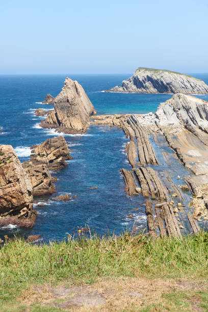 istock Cliffs surrounded by clear waters and blue skies 1389931749