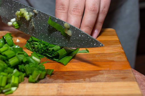 Cheese knives and fork on cutting board