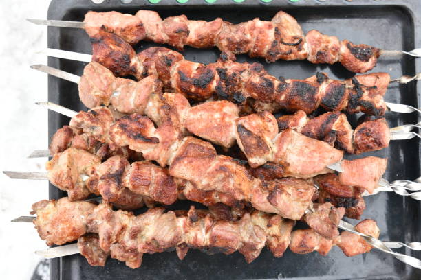 istock Pork meat shish kebab on a fire on coals 1389932134