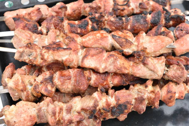 istock Pork meat shish kebab on a fire on coals 1389932135