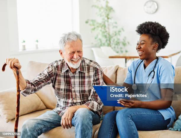 Nurse Doctor Senior Care Caregiver Help Assistence Retirement Home Nursing Elderly Man Woman Health Support African American Black Stock Photo - Download Image Now