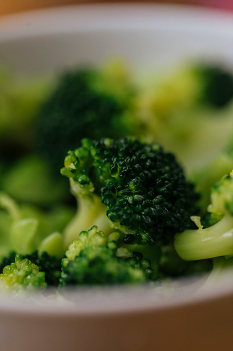 Macro photo of fresh green broccoli in a white bow