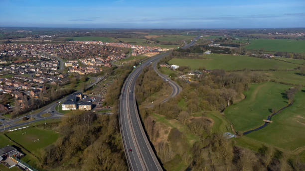 A high angle view of traffic on a dual carriageway passing next to Stowmarket in Suffolk, UK stock photo