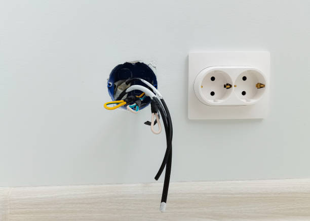 istock Installation of new electrical wiring, plastic socket and made socket. electric wires for future sockets sticking out of painted wall, home renovation concept 1389934610