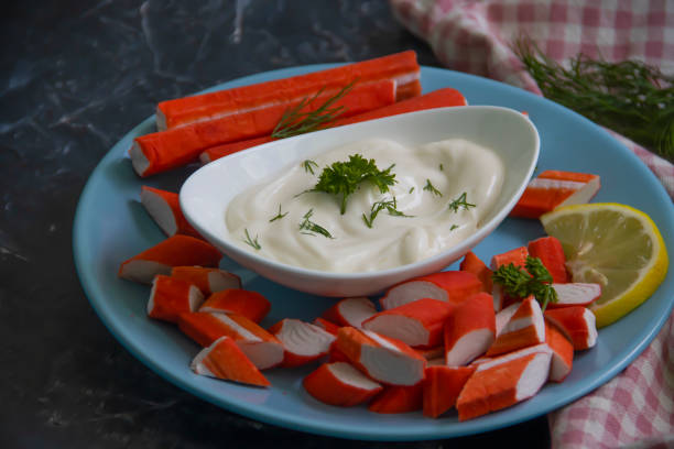 istock crab sticks, sauce in a plate on a wooden background 1389935268