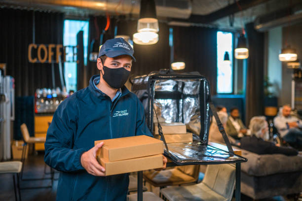 istock Asian Delivery Guy Wearing A Protective Face Mask 1389936098