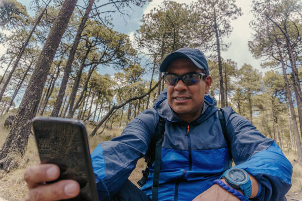 istock A man with phone in the forest 1389937006