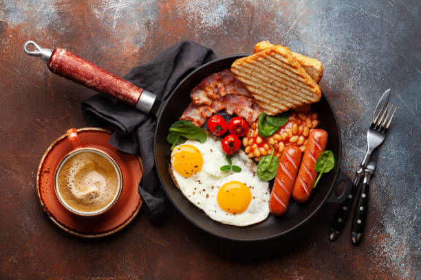 istock English breakfast with fried eggs, beans, bacon and sausages 1389937136