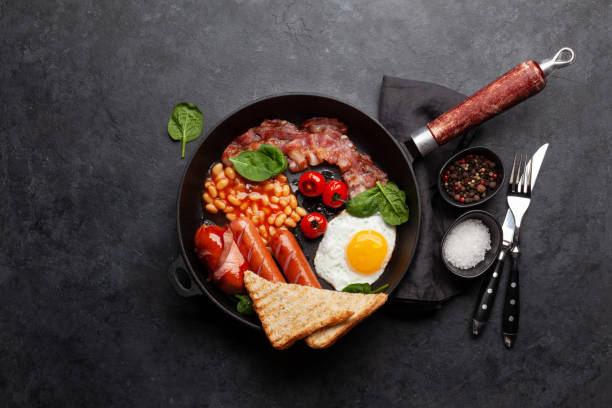 istock English breakfast with fried eggs, beans, bacon and sausages 1389937167
