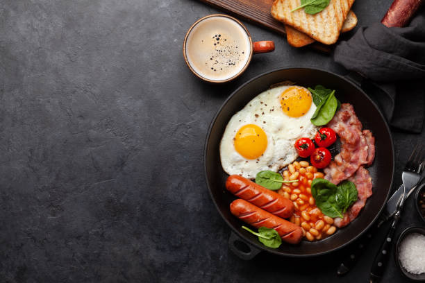 istock English breakfast with fried eggs, beans, bacon and sausages 1389937201