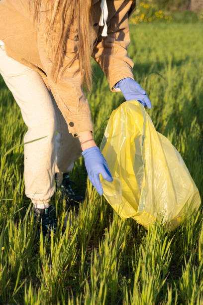istock woman collecting rubbish from nature 1389937577