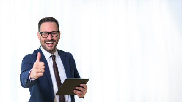 istock Portrait of young optimistic manager showing thumbs up 1389937704