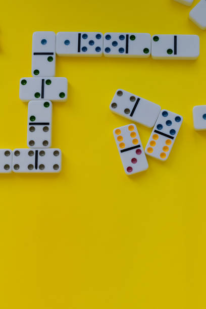 istock Domino board game on yellow background 1389941858