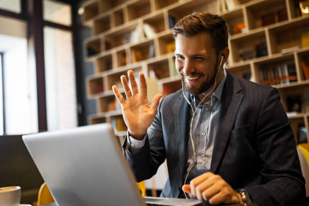 istock Young businessman making video call waving 1389941952