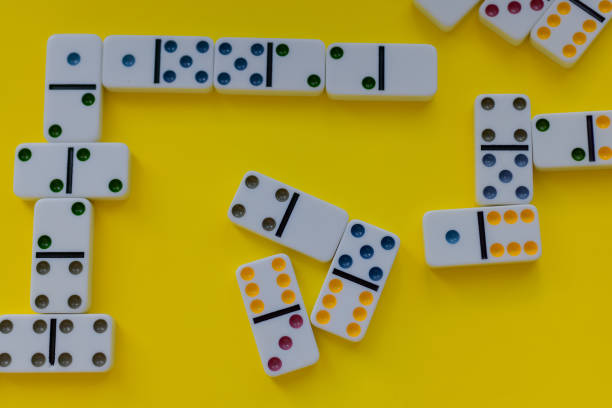 istock Domino board game on yellow background 1389942021