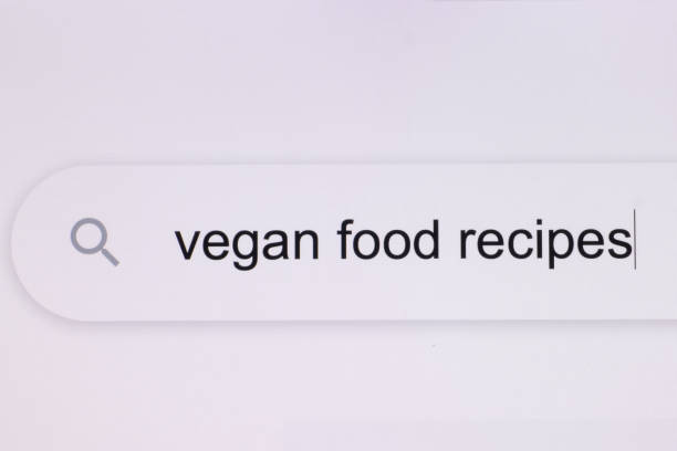 Vegan food recipes - pc screen internet browser search engine bar typing vegan food recipes related question. Typing the word vegan food recipes in the browser on a pixelated computer screen. recetas de comida vegana - pantalla de pc navegador de internet barra del motor de búsqueda escribiendo recetas de comida vegana pregunta relacionada. escribir la palabra recetas de comida vegana en el navegador en una pantalla de computadora pixelada