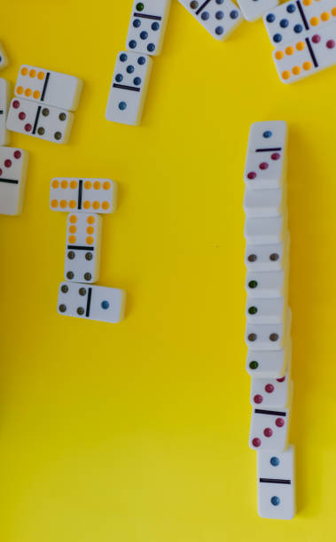 istock Domino board game on yellow background 1389942816