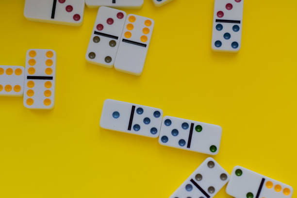 istock Domino board game on yellow background 1389942836