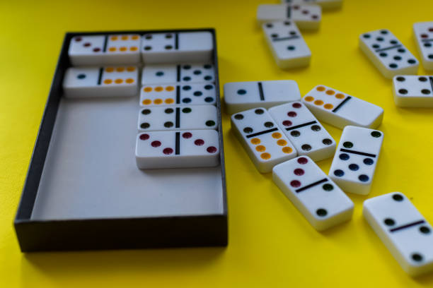 istock Domino board game on yellow background 1389942906