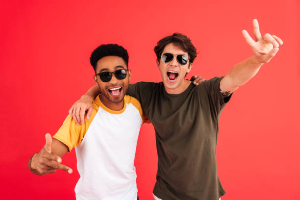 istock Two smiling cheerful men in sunglasses posing 1389942980