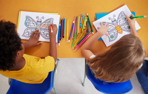 istock Shot of preschool students colouring in class 1389944234