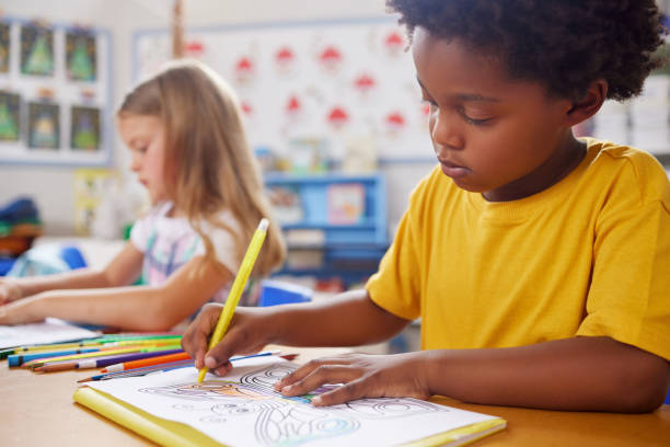 istock Shot of preschool students colouring in class 1389944237
