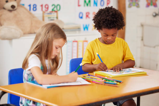 istock Shot of preschool students colouring in class 1389944243