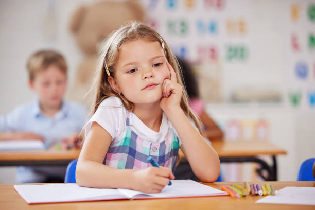 istock Shot of a preschool student looking thoughtful while sitting in class 1389944302