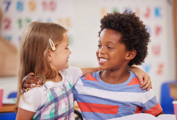 Shot of two preschool students sitting together in class