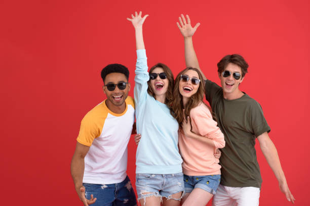 istock Young happy group of friends standing isolated 1389945867