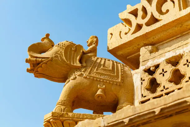 Photo of Elephant sculpture with a blind man on the Jian temple Amar Sagar, Jaisalmer area in Rajasthan, India, Asia
