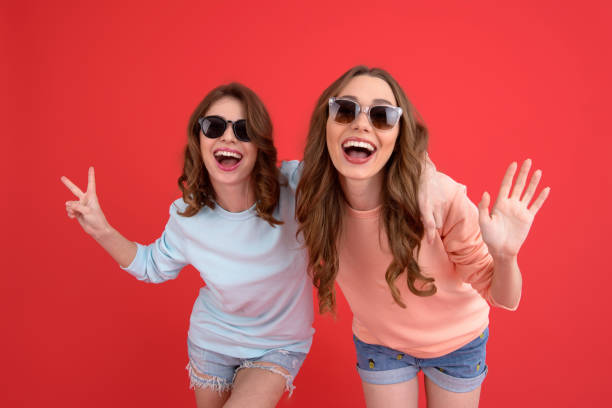 istock Happy ladies friends standing isolated 1389947081
