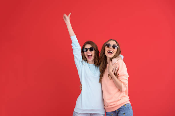 istock Happy ladies friends standing isolated 1389947147