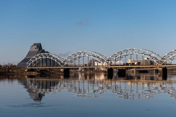 istock Train passing the railway bridge over the River Daugava in Riga, Latvia on a sunny spring day 1389947287