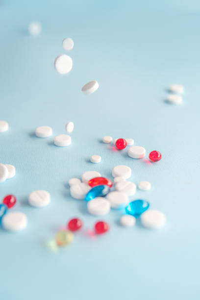 istock Mixed colorful gel capsules and white tablets 1389949792