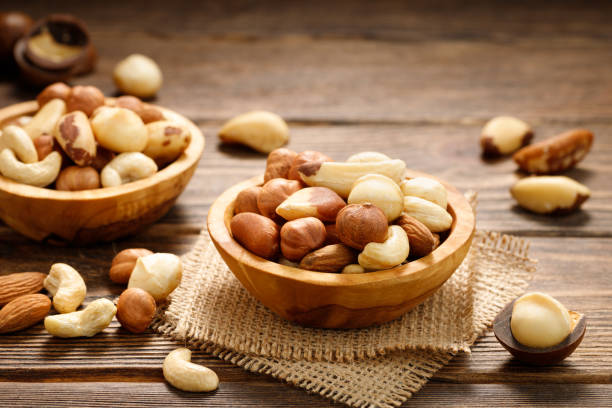 istock Various nuts in bowl - cashew, hazelnuts, almonds, brazilian nuts and macadamia. 1389950241