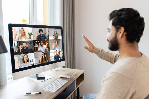 istock Happy and optimistic Indian man in casual wear using computer in modern office, successful inspired arabic male entrepreneur looks at the screen and smiles thoughtfully 1389952785