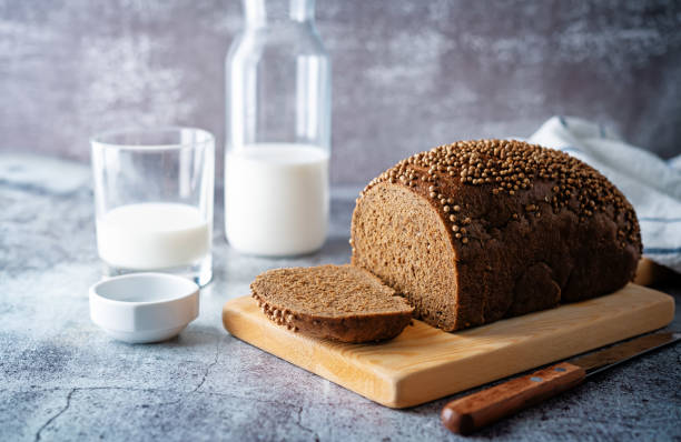 istock Rye bread with coriander sprinkled with glasses of milk 1389954196