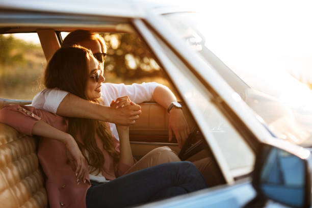 istock Beautiful young couple embracing while sitting together 1389954631