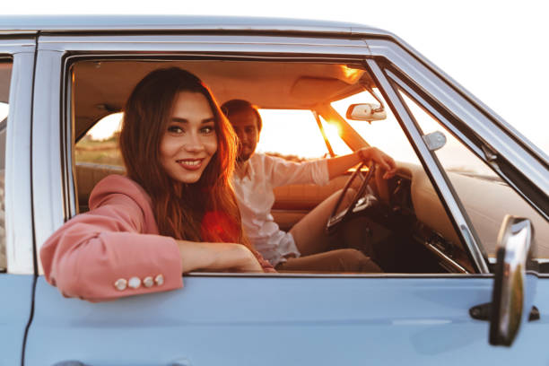 istock Beautiful smiling young woman sitting inside a car 1389954785