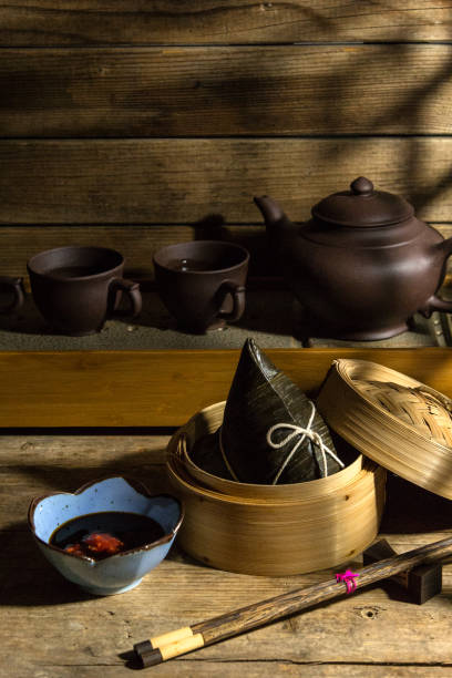 istock Rice dumpling zongzi in steaming basket with tea set 1389955696