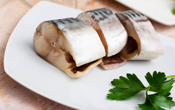 istock Slices of lightly salted mackerel fish served with  greens 1389955741