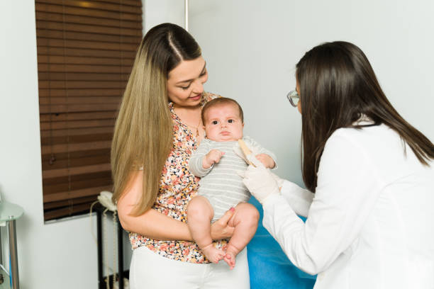 istock Mom and newborn baby on a check-up 1389958088