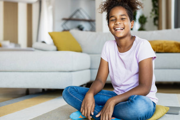 istock Young girl sitting on the floor 1389959072