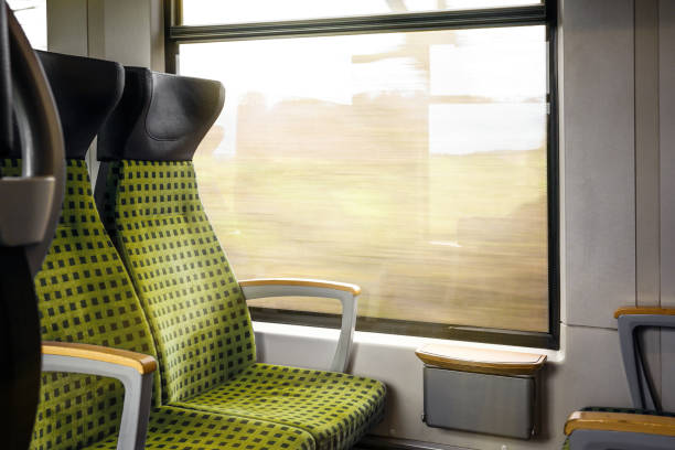 istock Upholstered seats by the window inside a moving train, concept for traffic, transport and travel, copy space 1389959230