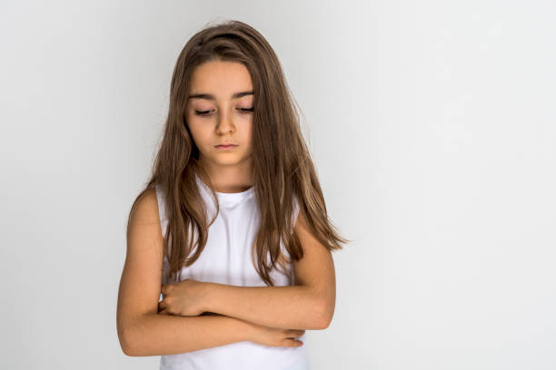 istock Girl put his hands on chest looking sad 1389960482