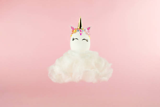 istock Easter unicorn egg flying on cloud on pastel pink background. Happy easter banner. Kids activity inspiration. Greeting card or poster. Copy space for text. Levitation egg 1389961314