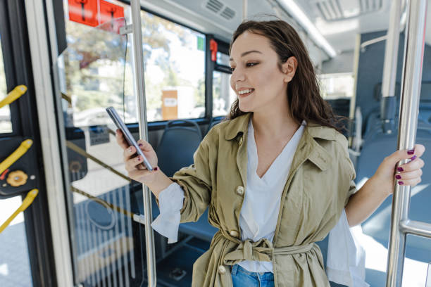 istock Woman in a public transport using mobile phone 1389962657