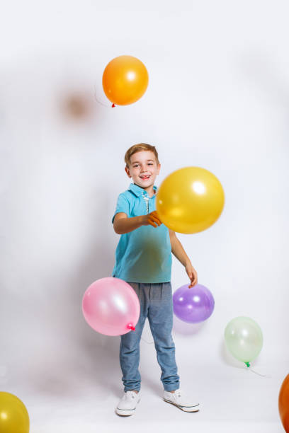 Portrait of a happy cute little kid with balloons stock photo